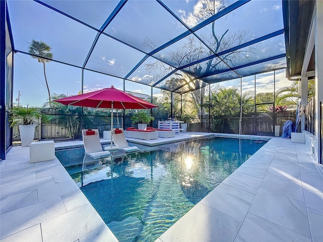 view of pool with a patio and glass enclosure