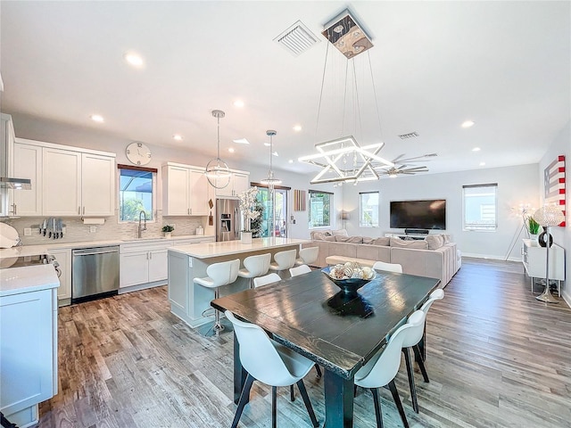 dining area featuring a wealth of natural light and light hardwood / wood-style flooring