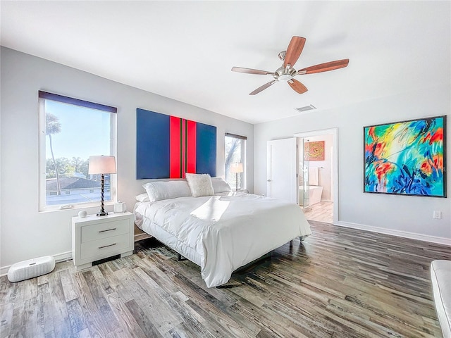 bedroom featuring ceiling fan, ensuite bathroom, and hardwood / wood-style floors