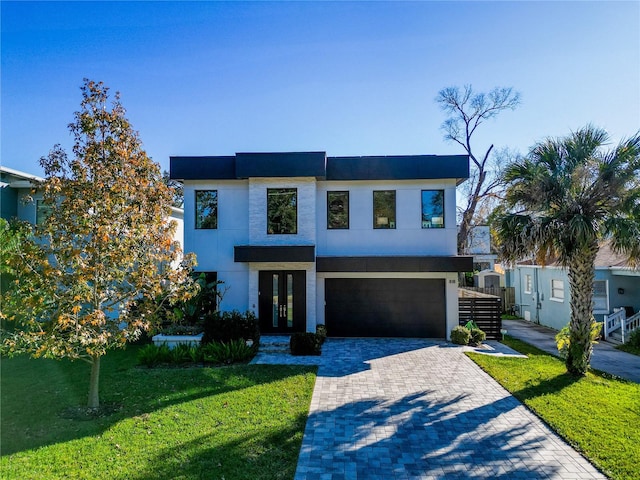 view of front of home featuring a garage and a front lawn