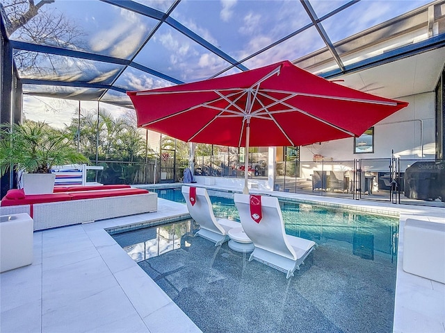 outdoor pool featuring glass enclosure and a patio area