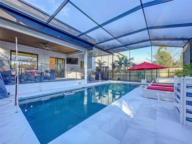 view of pool featuring glass enclosure, a patio area, and fence