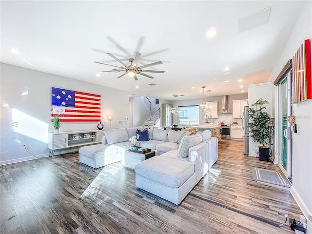 living room featuring hardwood / wood-style floors, sink, and ceiling fan