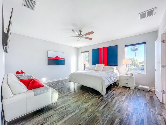 bedroom featuring visible vents, baseboards, and wood finished floors