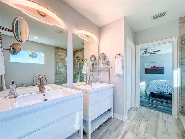 bathroom featuring ceiling fan, vanity, and an enclosed shower