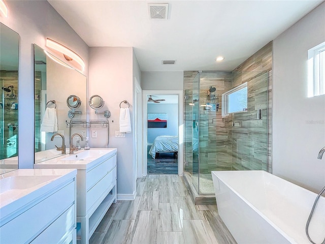 full bath featuring two vanities, visible vents, and a stall shower