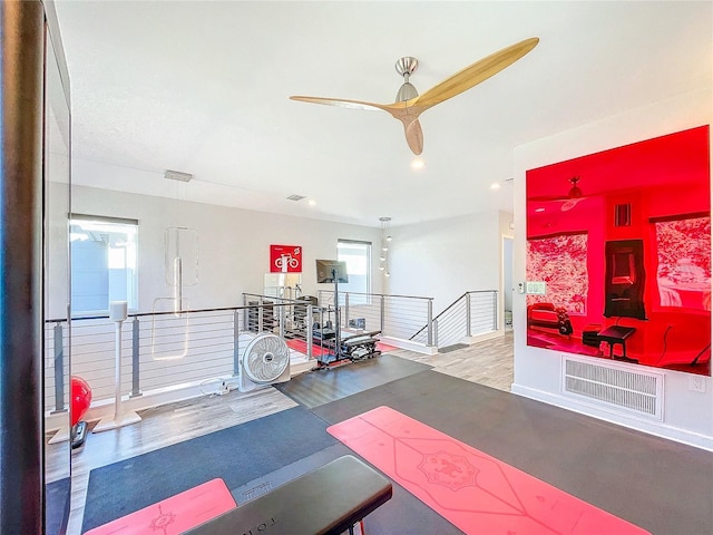 workout area featuring visible vents, wood finished floors, and a ceiling fan