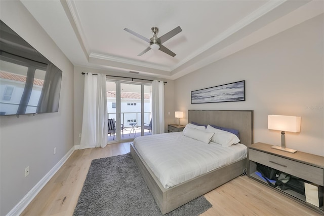 bedroom with light wood-type flooring, access to outside, ornamental molding, a raised ceiling, and ceiling fan