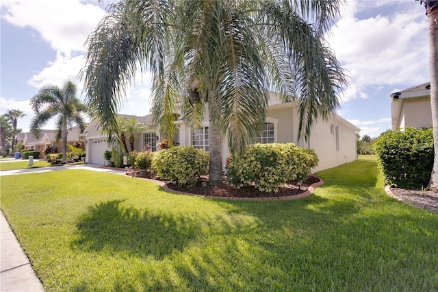 exterior space featuring a garage and a front lawn