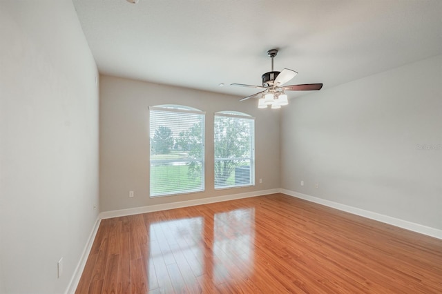 spare room featuring ceiling fan and light hardwood / wood-style floors