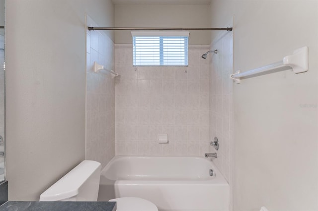 bathroom featuring tiled shower / bath and toilet