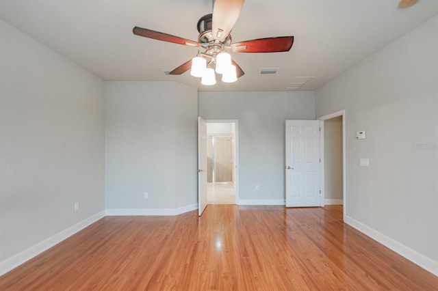 spare room featuring ceiling fan and light hardwood / wood-style floors