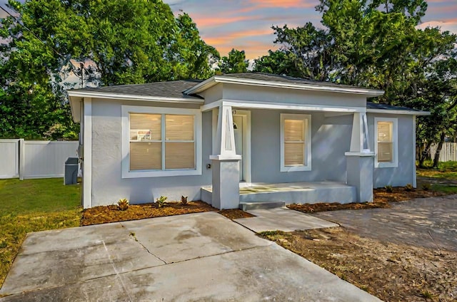 view of front of property with a yard and a porch