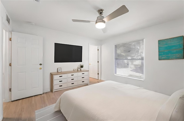 bedroom with light hardwood / wood-style floors and ceiling fan