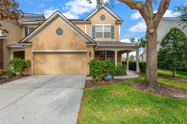 view of property featuring a garage and a front yard