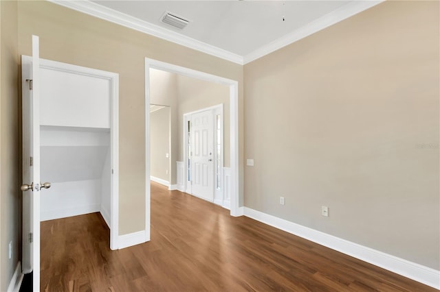 spare room featuring hardwood / wood-style floors and crown molding