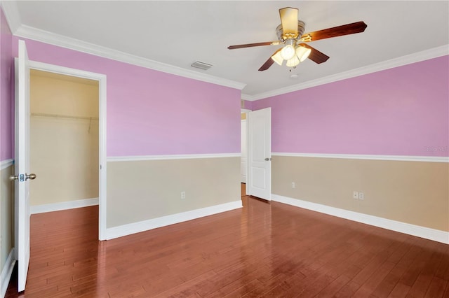 interior space featuring crown molding, wood-type flooring, and ceiling fan