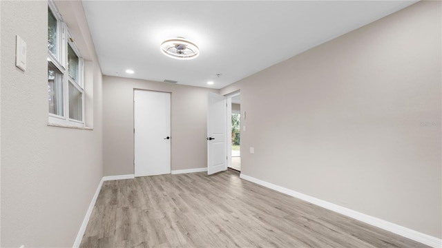 spare room featuring light wood-type flooring