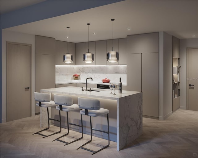 kitchen featuring a kitchen island with sink, decorative backsplash, and light parquet floors