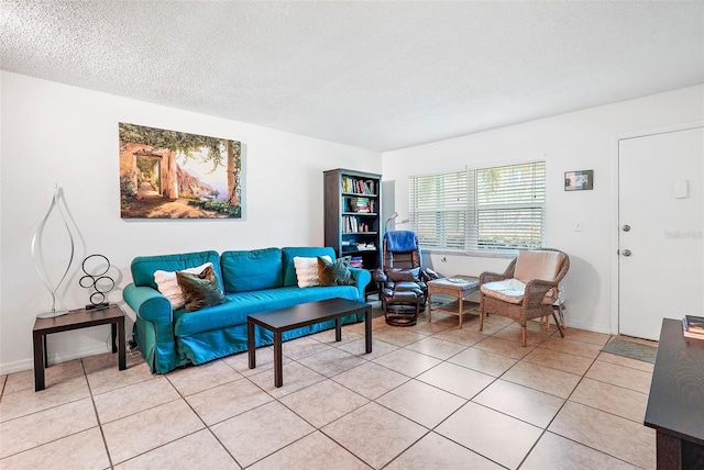 tiled living room featuring a textured ceiling