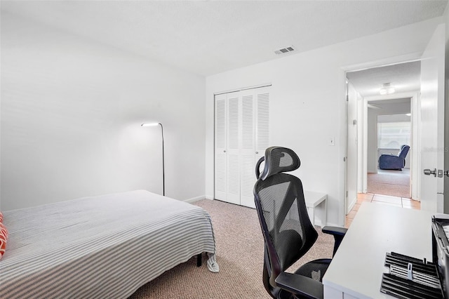 carpeted bedroom featuring a closet