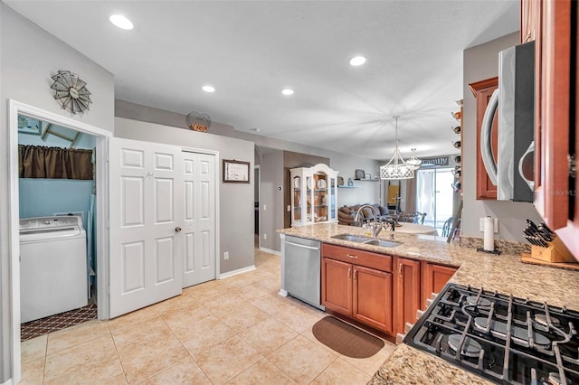 kitchen featuring sink, light stone counters, dishwasher, kitchen peninsula, and washer / clothes dryer