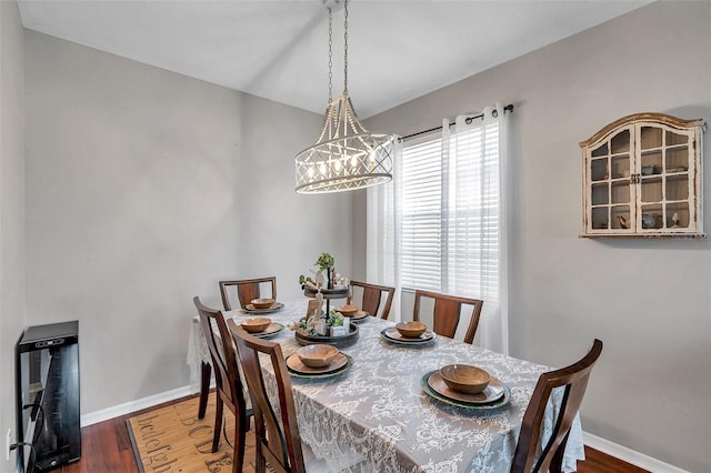 dining space with hardwood / wood-style flooring