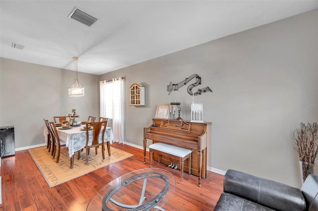 dining space with hardwood / wood-style flooring