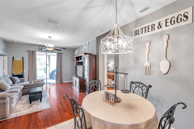 dining area with ceiling fan and hardwood / wood-style floors