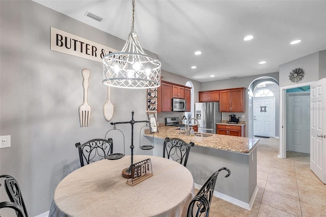 tiled dining room featuring sink