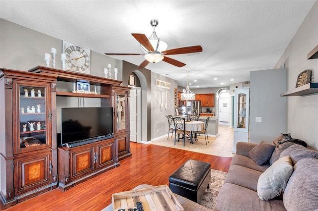 living room with ceiling fan and light hardwood / wood-style floors