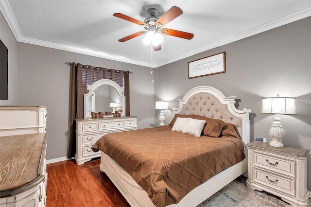 bedroom featuring ceiling fan, ornamental molding, dark hardwood / wood-style flooring, and a textured ceiling