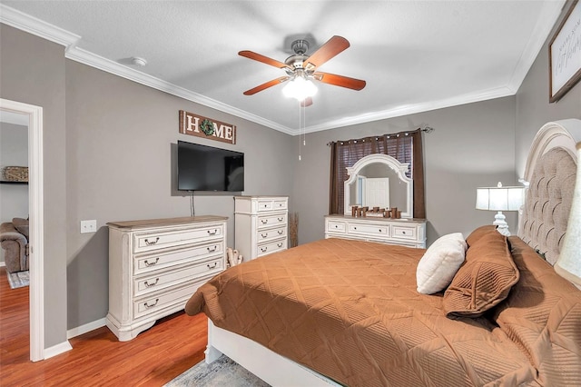 bedroom featuring crown molding, ceiling fan, and light hardwood / wood-style floors