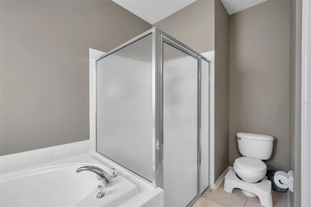 bathroom featuring independent shower and bath, tile patterned flooring, and toilet