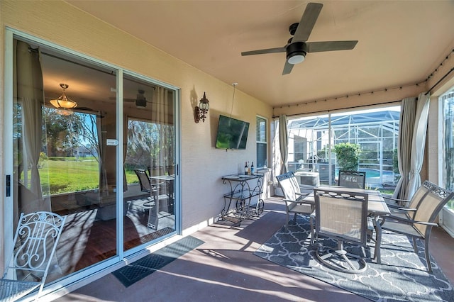 sunroom featuring ceiling fan