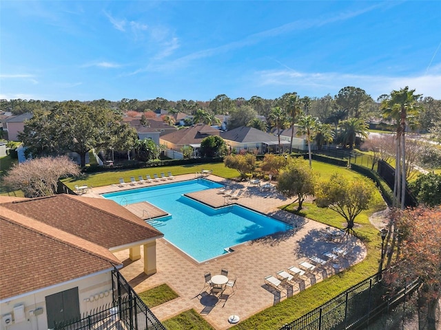 view of pool with a patio area and a lawn