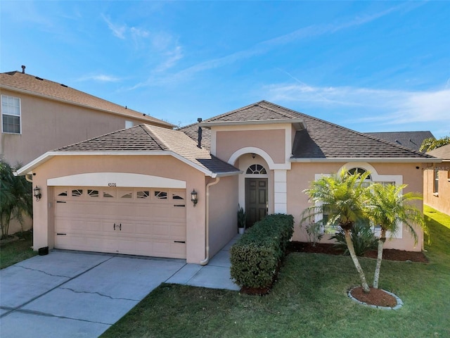 ranch-style house with a garage and a front lawn