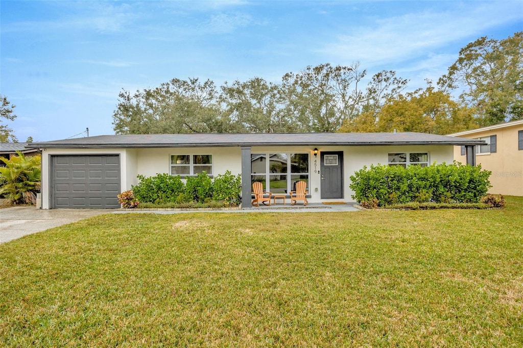 ranch-style home with a garage and a front yard