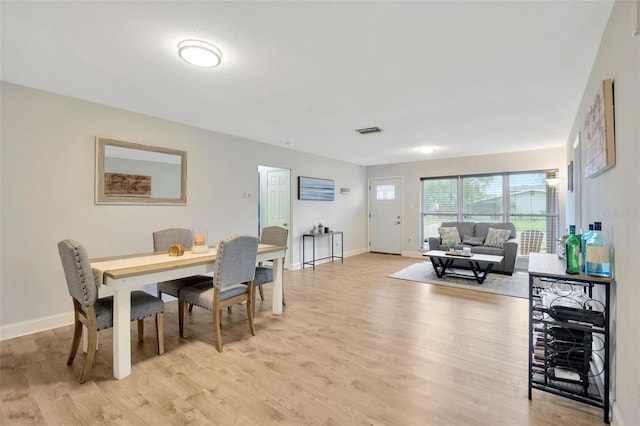 dining space with light hardwood / wood-style floors