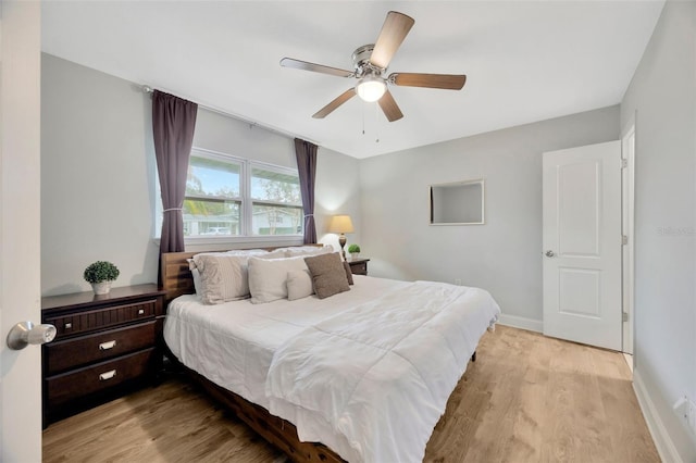 bedroom with light hardwood / wood-style flooring and ceiling fan