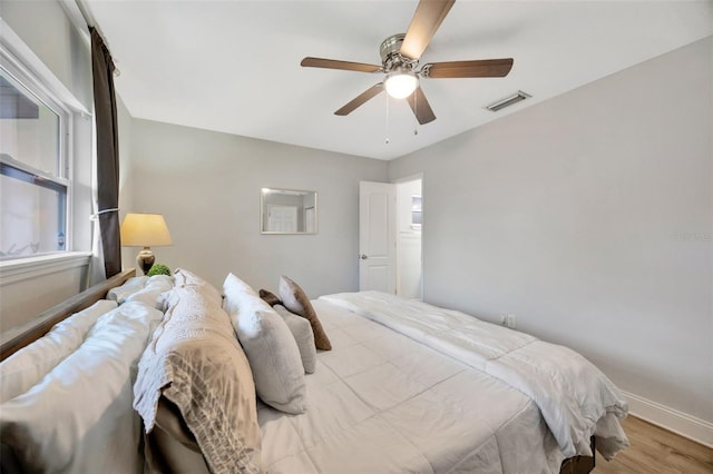 bedroom with ceiling fan and light wood-type flooring