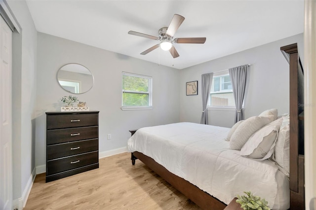 bedroom with ceiling fan and light hardwood / wood-style flooring