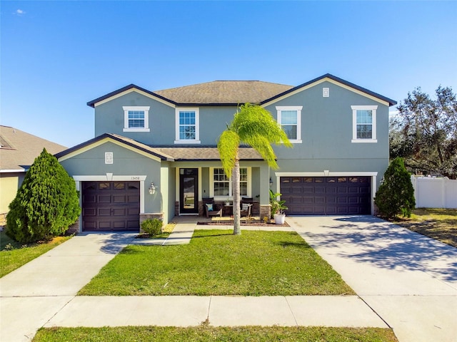 view of front facade with a garage and a front yard