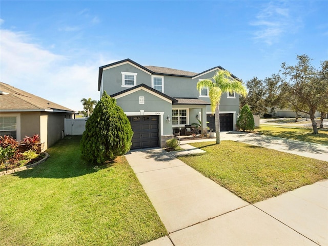 view of front property featuring a garage and a front lawn