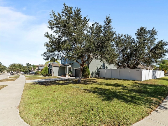 view of front facade with a garage and a front lawn