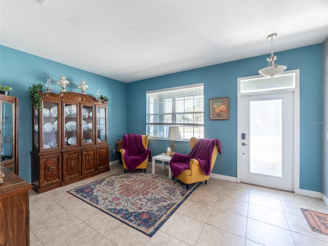 living area featuring light tile patterned floors and a textured ceiling