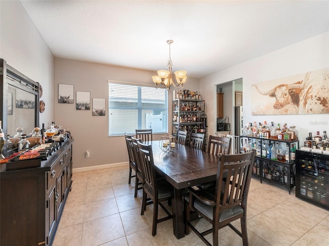 tiled dining room with a notable chandelier, beverage cooler, and a textured ceiling