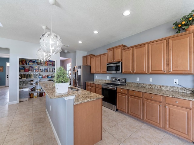 kitchen featuring an island with sink, appliances with stainless steel finishes, light tile patterned floors, and light stone counters