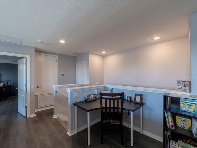 kitchen with dark wood-type flooring and a textured ceiling