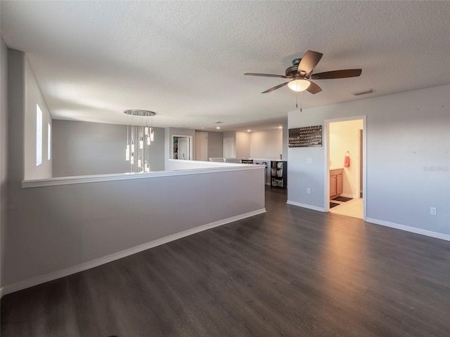 unfurnished room with dark hardwood / wood-style floors, a textured ceiling, and ceiling fan